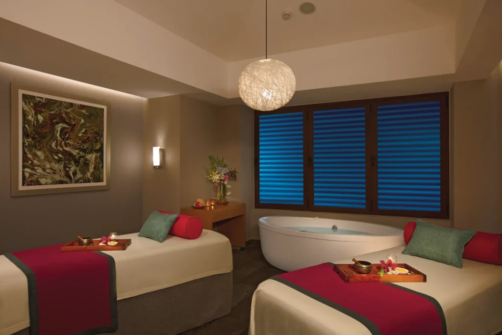 Private spa treatment room with massage beds and calming ambiance at Dreams Playa Mujeres Resort.