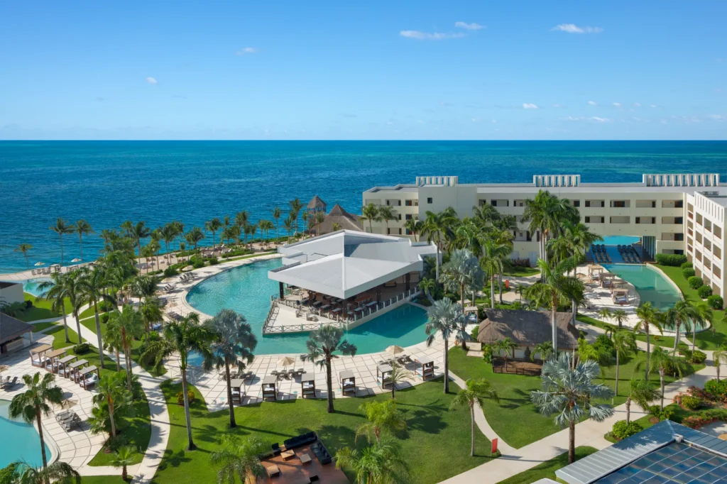 Aerial view of main pool and beachfront at Dreams Puerto Morelos Resort & Spa in Riviera Maya.