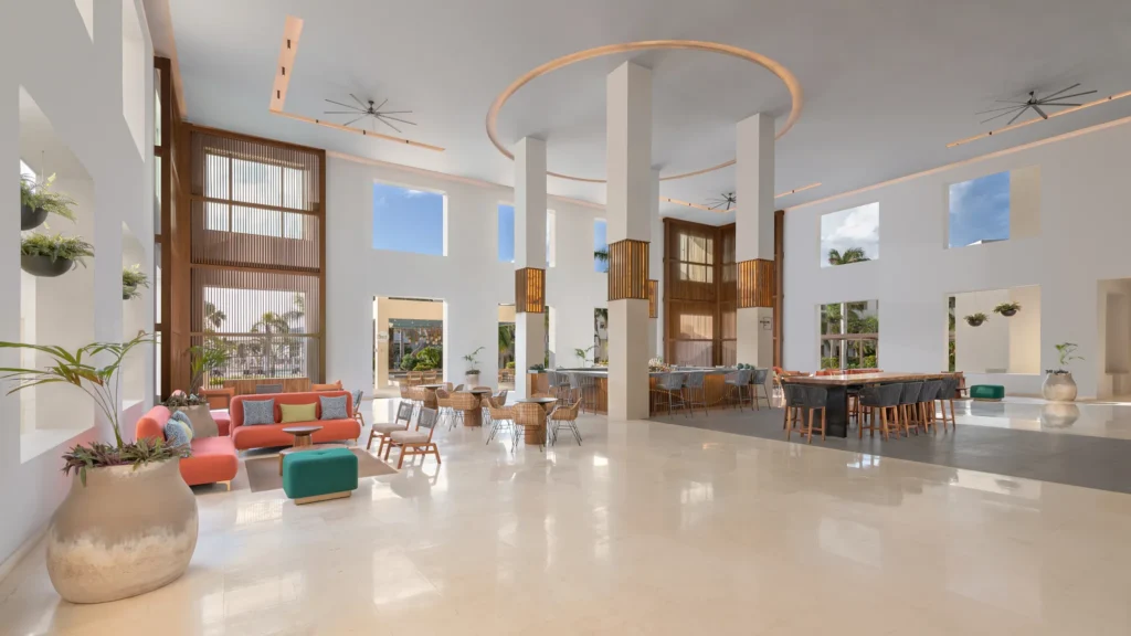 Infusions lobby bar at Dreams Puerto Morelos Resort & Spa featuring a spacious open-air lounge, modern seating, and bright contemporary design.