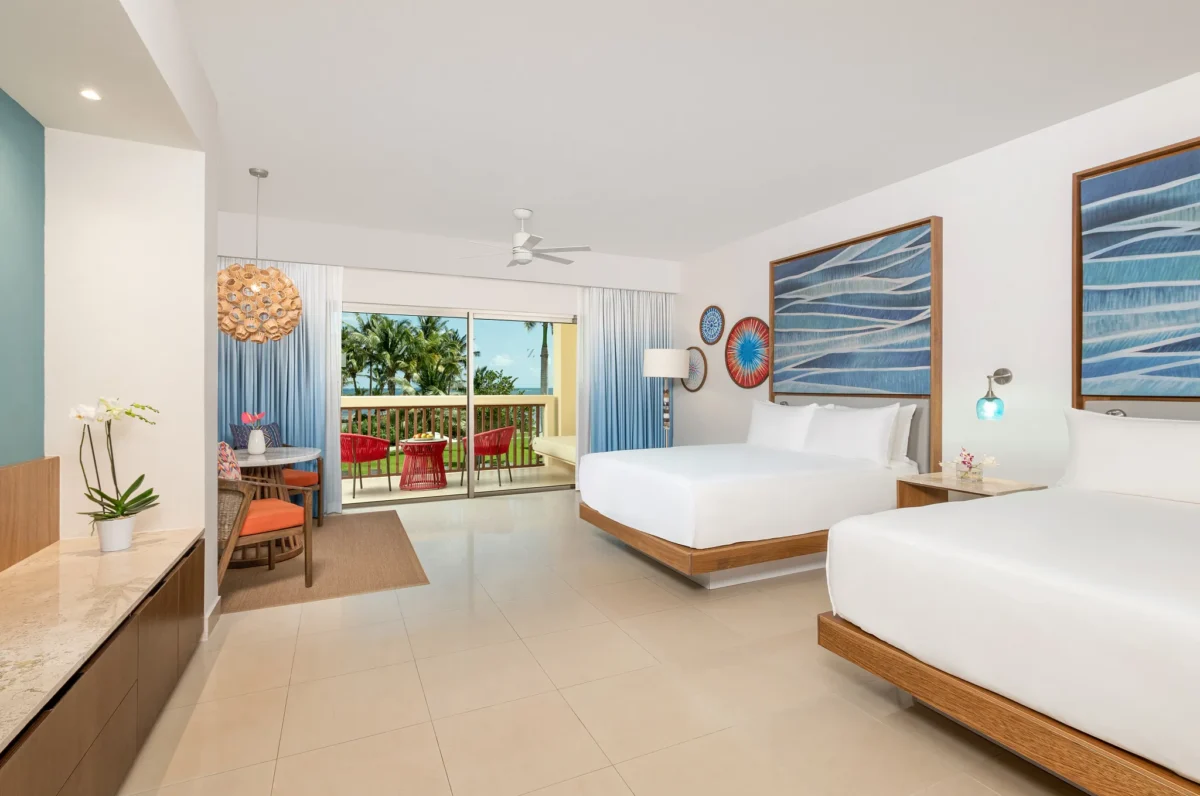 Junior Suite Tropical View Double room with two beds and balcony access at Dreams Puerto Morelos Resort.