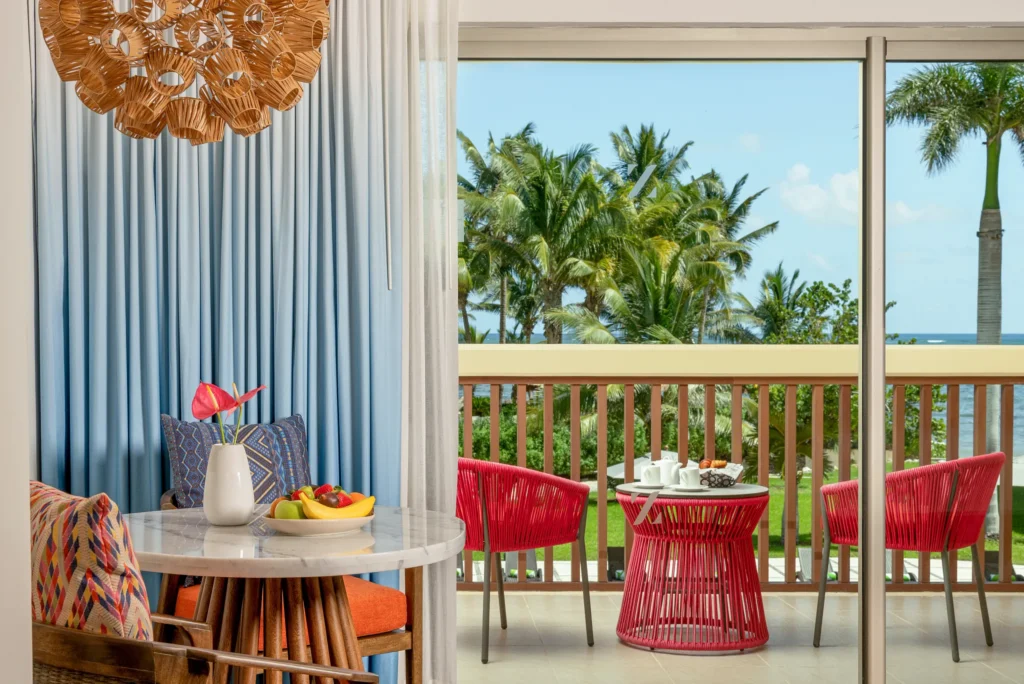 Junior Suite Tropical View living area with balcony and tropical garden views at Dreams Puerto Morelos Resort.