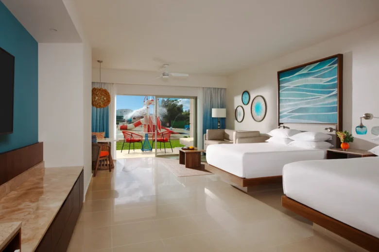 Junior Suite Waterpark View Double room with two beds and balcony overlooking waterpark at Dreams Puerto Morelos.