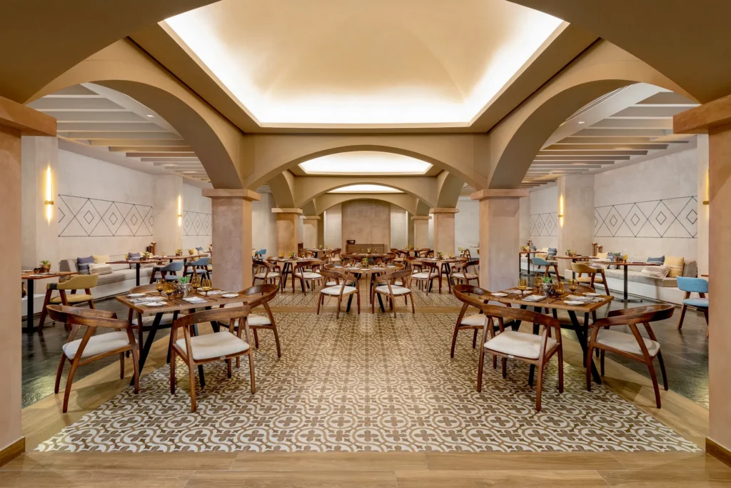 Ki Mexican restaurant at Dreams Puerto Morelos Resort & Spa featuring elegant arched architecture, warm lighting, and traditional décor.