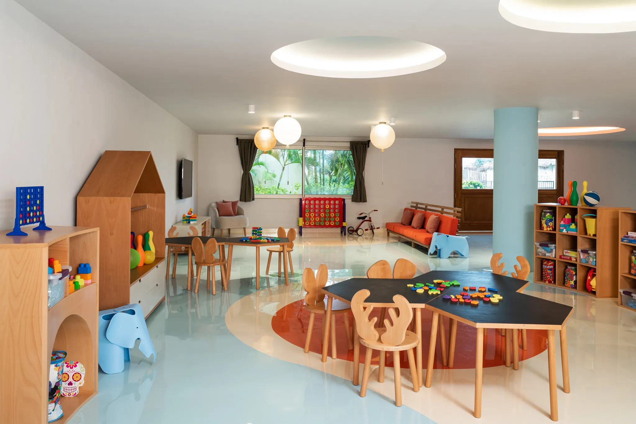 Bright kids club playroom with toys, tables, and colorful activities at Dreams Puerto Morelos Resort & Spa.