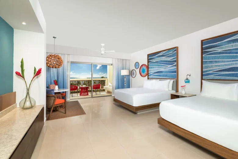 Preferred Club Junior Suite Ocean Front Double with two double beds and ocean view balcony at Dreams Puerto Morelos.