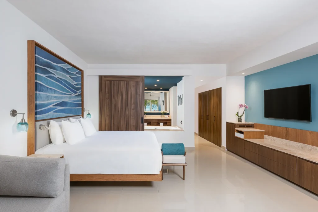 Preferred Club Junior Suite Ocean Front King bedroom with king bed and modern furnishings at Dreams Puerto Morelos.
