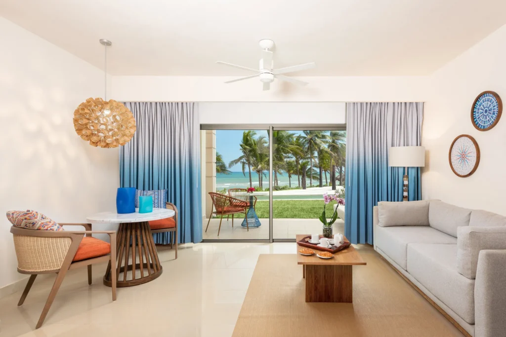 Preferred Club Junior Suite Ocean Front King living area with terrace and ocean view at Dreams Puerto Morelos Resort & Spa.