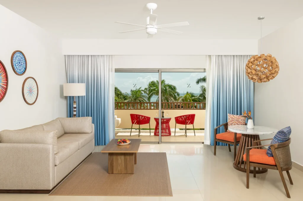 Preferred Club Junior Suite Ocean View King living area with balcony and ocean view at Dreams Puerto Morelos.