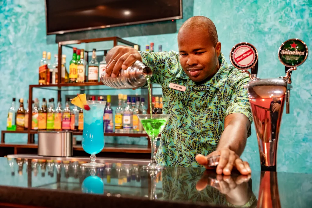 Cricket Club bar at Dreams Rose Hall Resort & Spa featuring classic pub-style décor, premium drinks, and a relaxed lounge atmosphere.
