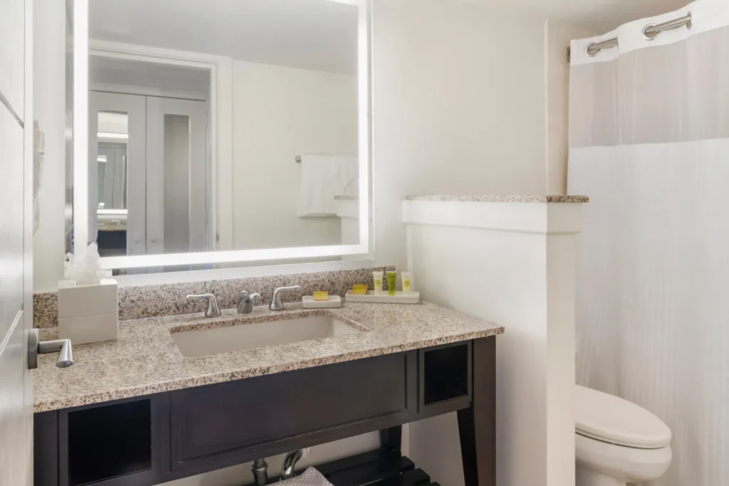 Mountain View bathroom with granite vanity and full bath at Dreams Rose Hall Resort & Spa.