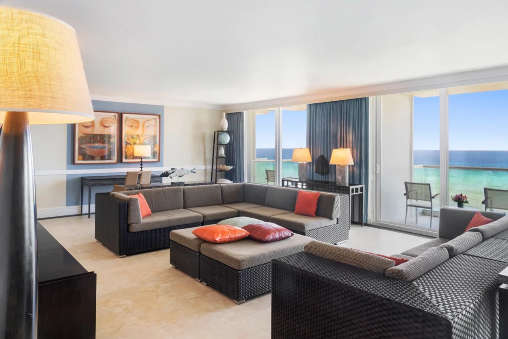 Oceanfront Prime Minister Suite living area with panoramic ocean views at Dreams Rose Hall Resort & Spa.