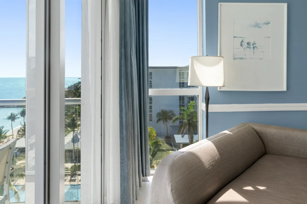 Oceanfront suite seating area with panoramic Caribbean Sea views at Dreams Rose Hall Resort & Spa.