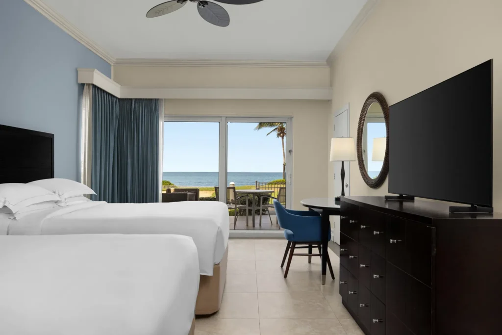 Oceanfront Walkout two queen room with direct terrace access at Dreams Rose Hall Resort & Spa.
