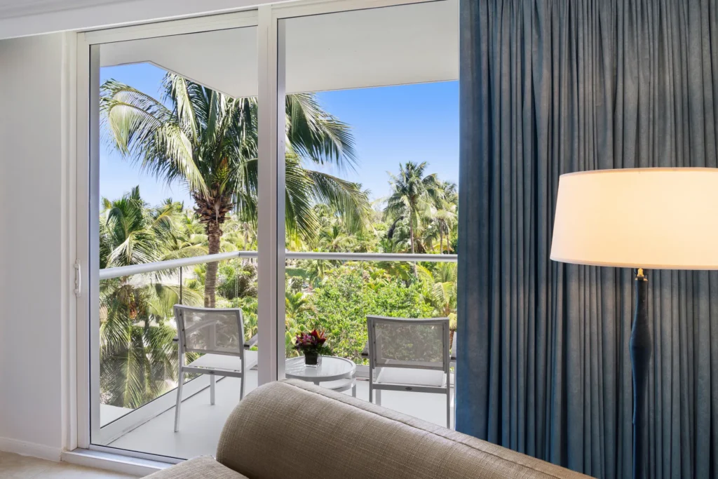 Private furnished balcony with tropical resort views at Dreams Rose Hall Resort & Spa in Jamaica.