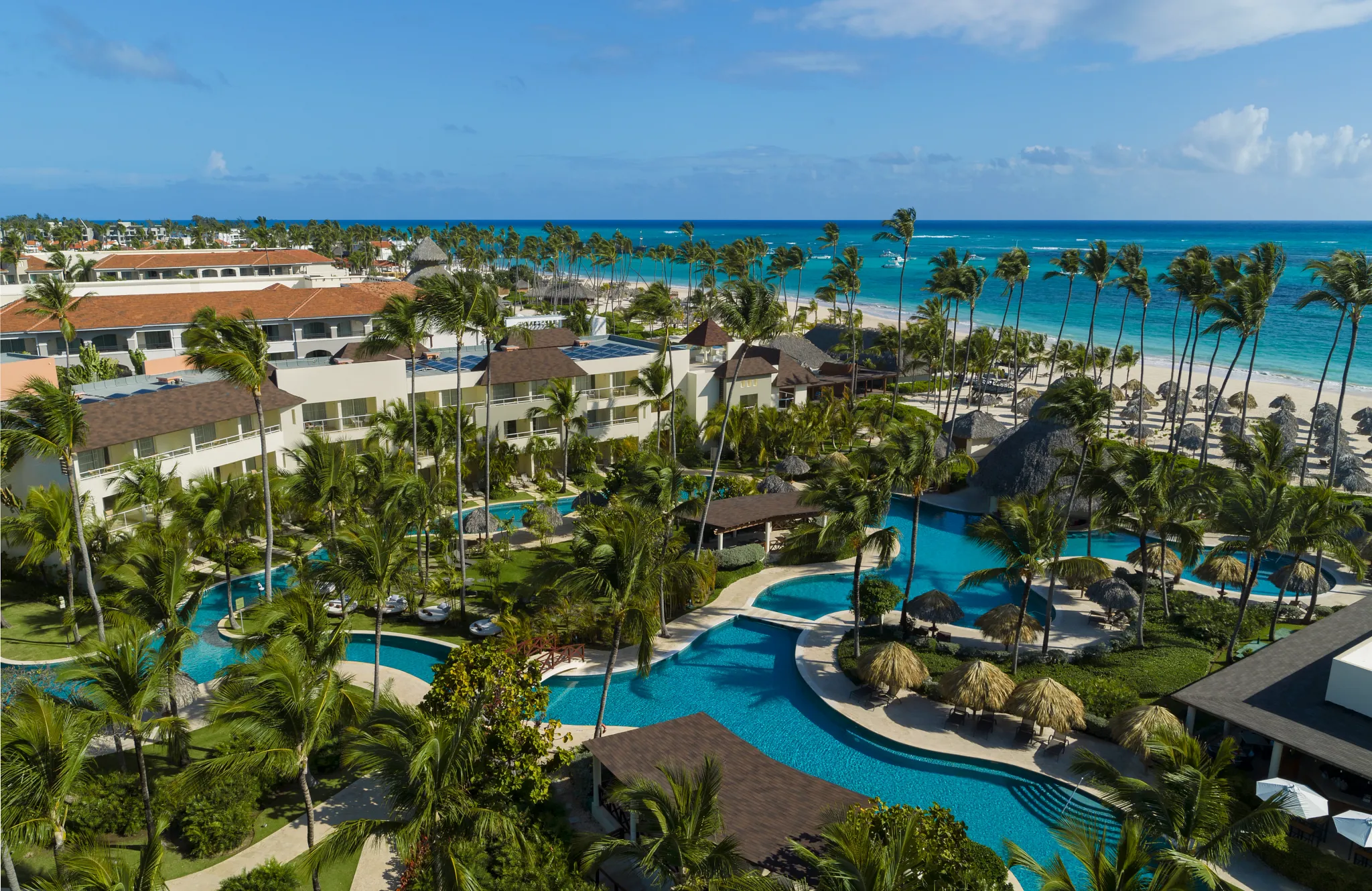 Aerial view of Dreams Royal Beach Punta Cana with pools, palm trees, and beachfront along the Caribbean Sea.