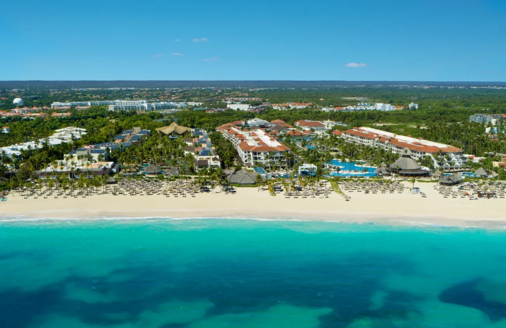 Aerial view of Dreams Royal Beach Punta Cana showcasing beachfront pools, palm-lined grounds, and white sand beach along the Caribbean Sea.