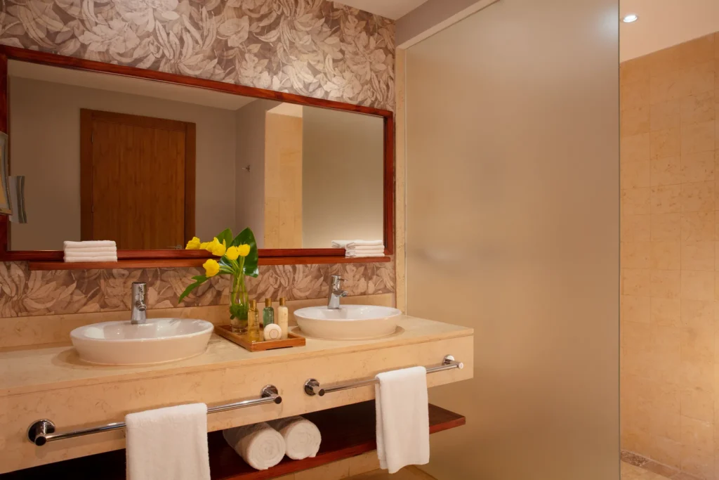 Deluxe Pool View bathroom with double sinks and walk-in shower at Dreams Royal Beach Punta Cana.
