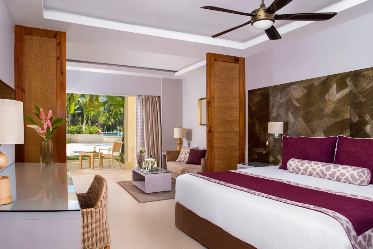 Deluxe Pool View room with king bed, seating area, and terrace at Dreams Royal Beach Punta Cana.