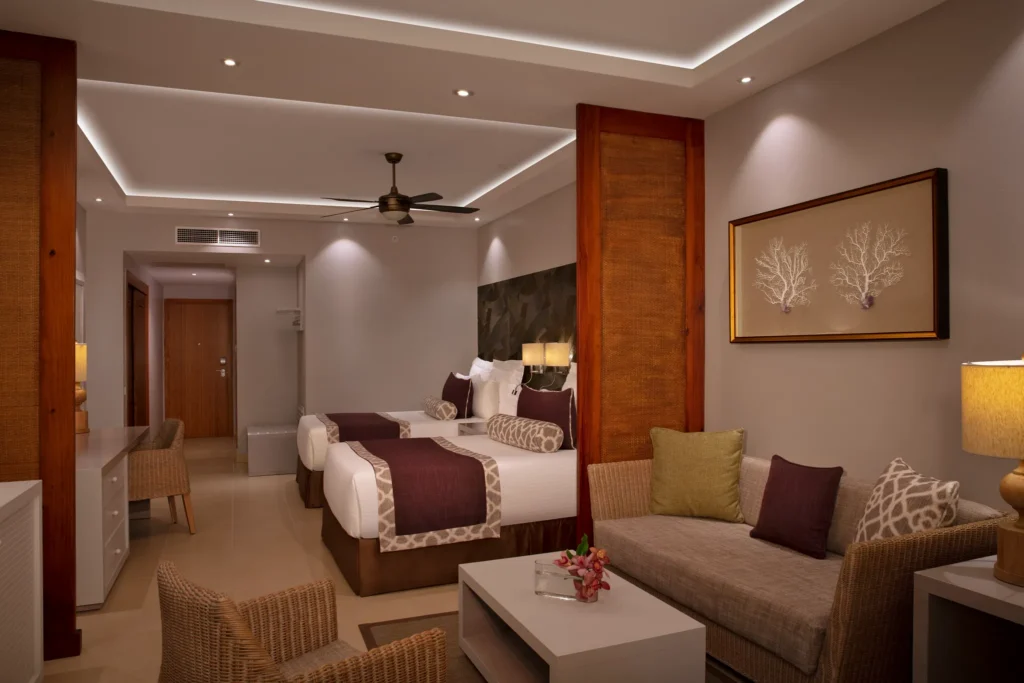 Deluxe Room with two double beds and living area at Dreams Royal Beach Punta Cana resort.