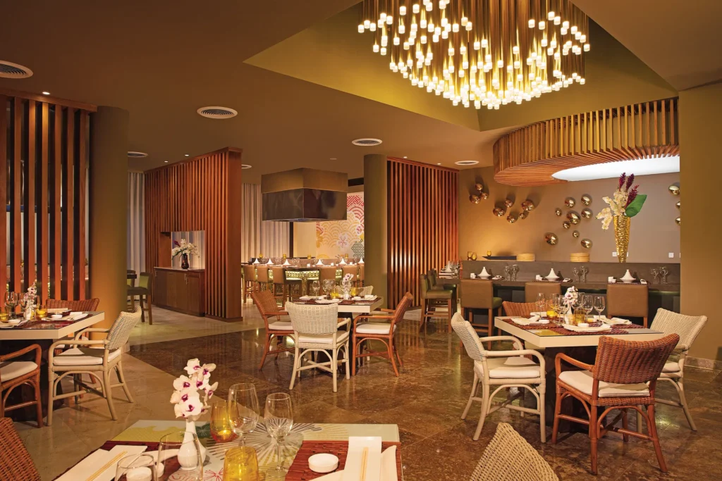 Fusion Asian restaurant at Dreams Royal Beach Punta Cana featuring teppanyaki tables, live cooking, and an elegant dining atmosphere.