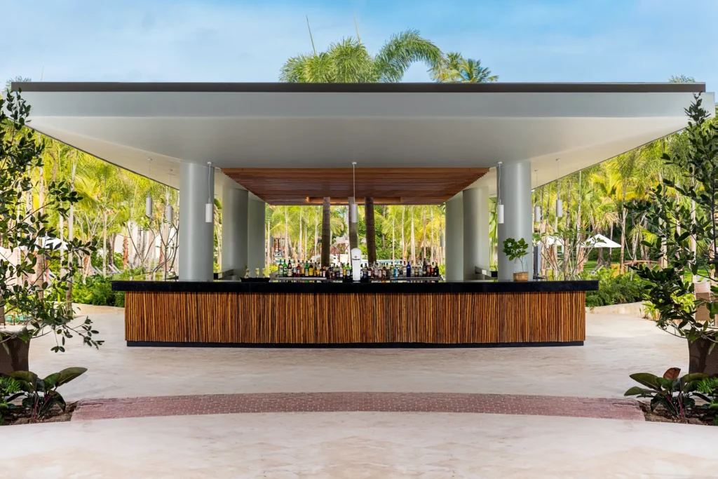 Interlude main plaza bar at Dreams Royal Beach Punta Cana featuring an open-air central location with stylish seating and evening ambiance.