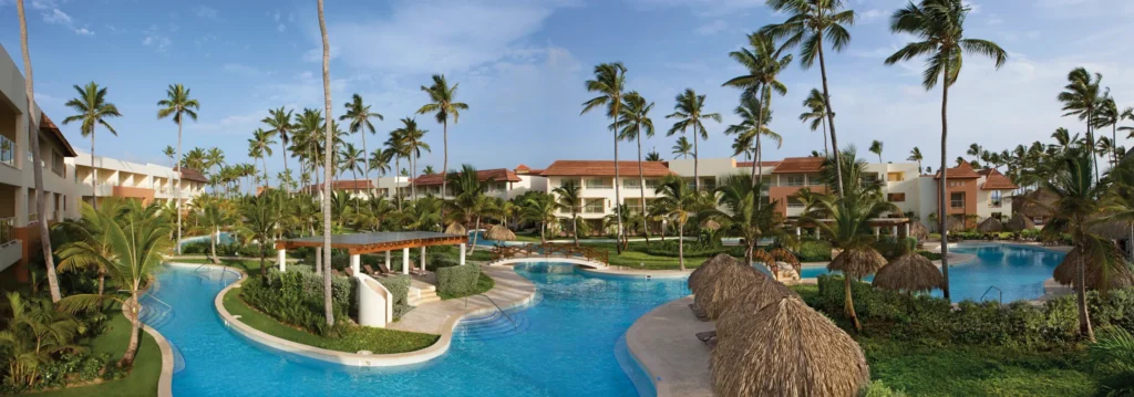 Panoramic view of pools, palm trees, and resort buildings at Dreams Royal Beach Punta Cana.