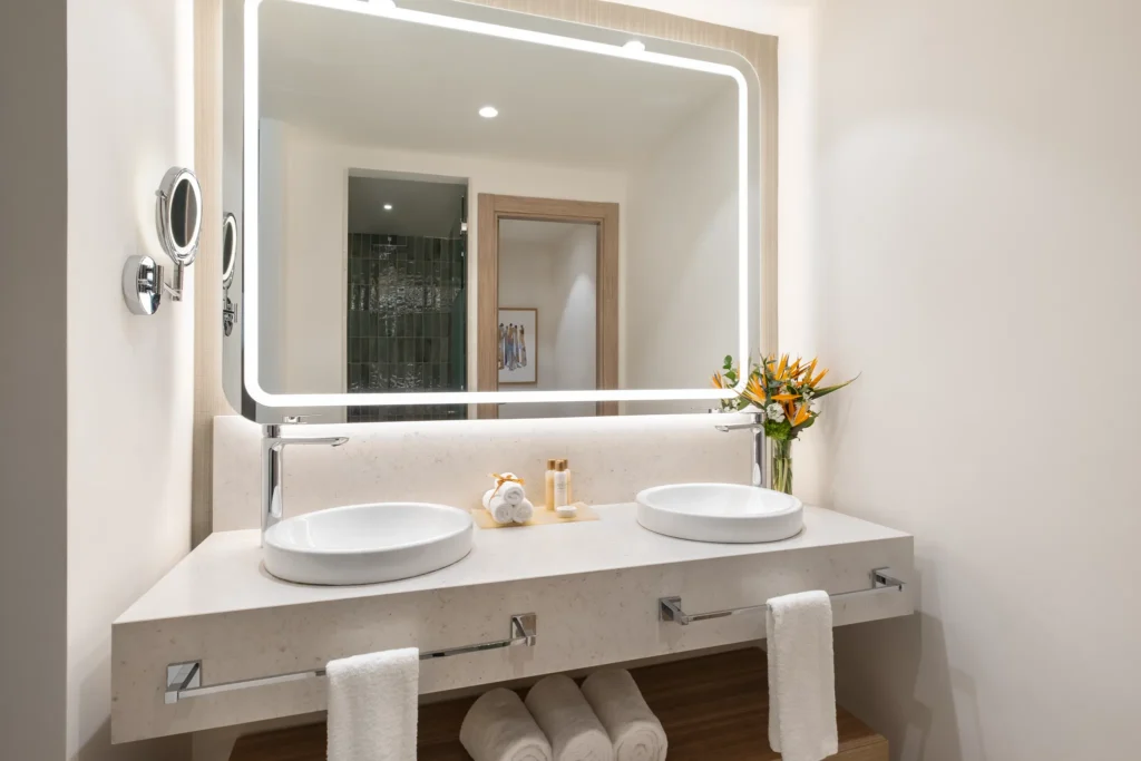 Preferred Club Family Junior Suite bathroom with double sinks and illuminated mirror at Dreams Royal Beach Punta Cana.
