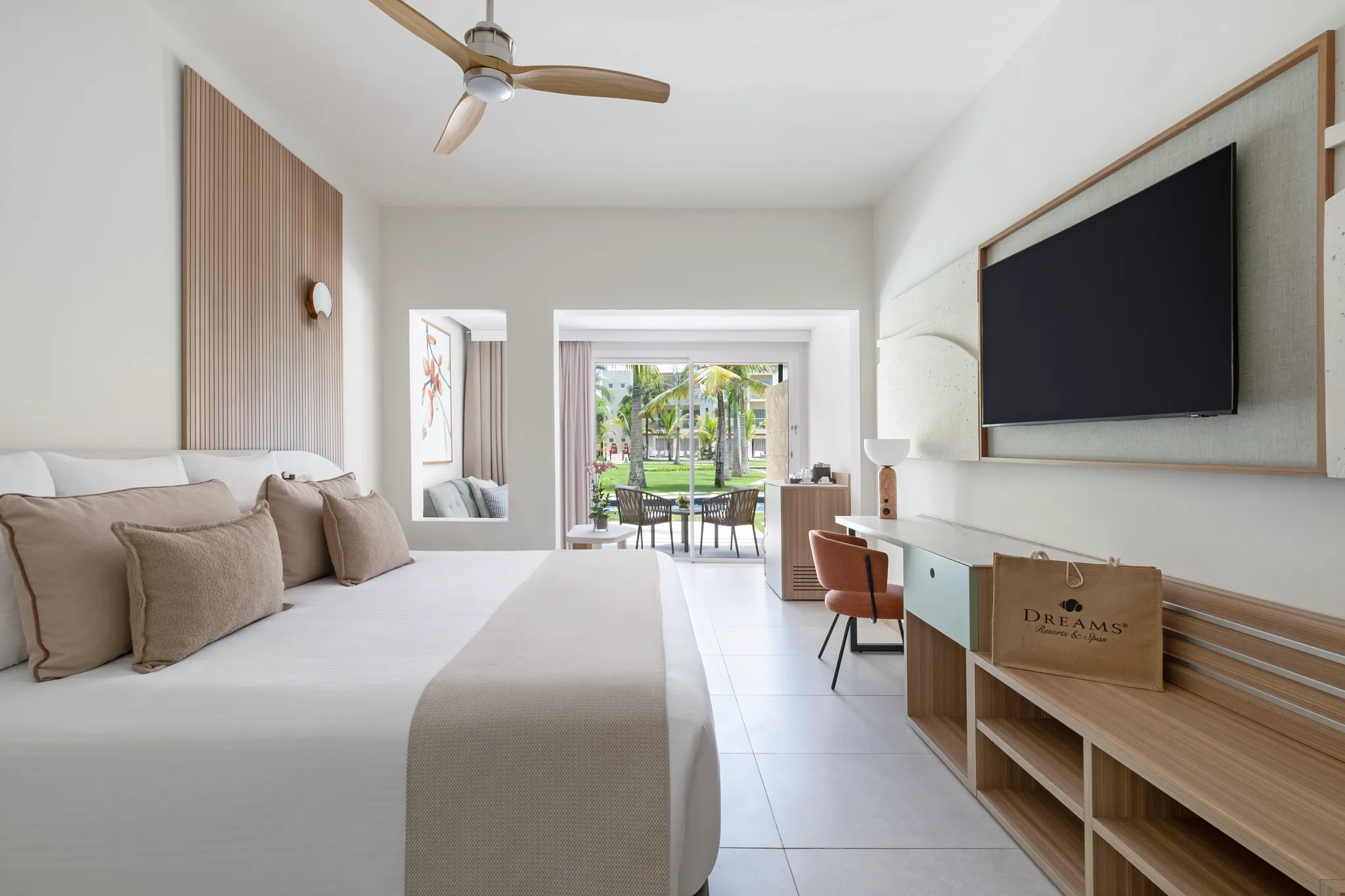 King bedroom with TV, desk, and sliding doors leading to terrace.
