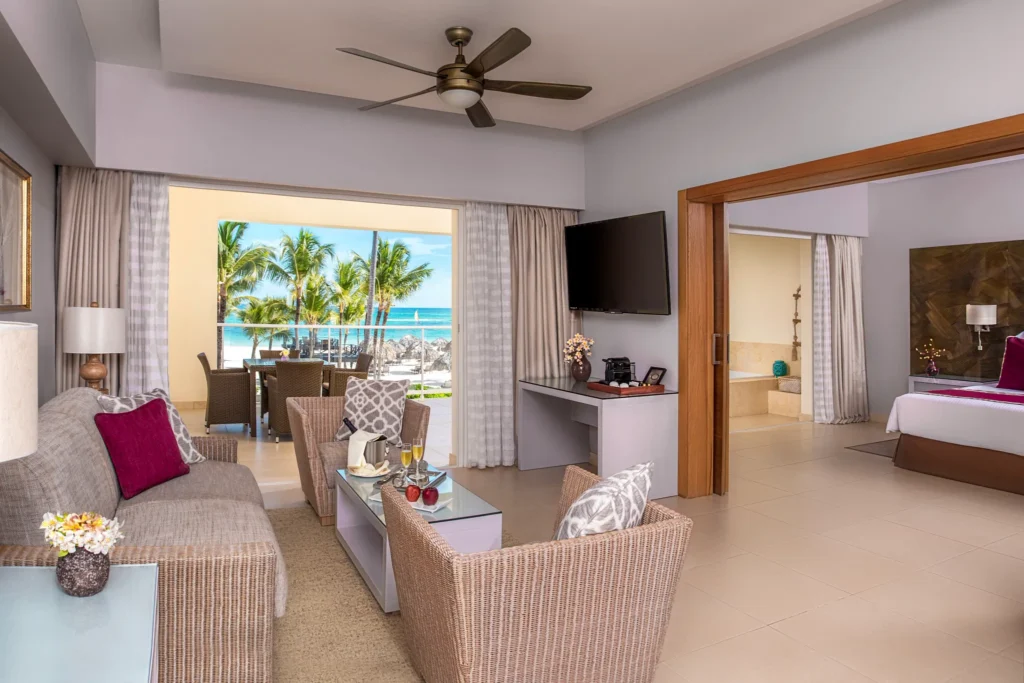 Living area with sofa seating, coffee table, and ocean view balcony access.