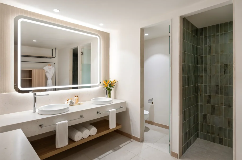 Preferred Club Premium Suite bathroom with double sinks and illuminated mirror at Dreams Royal Beach Punta Cana.