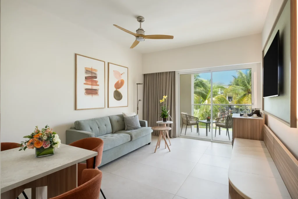 Preferred Club Premium Suite Garden View living room with sofa bed and balcony access at Dreams Royal Beach Punta Cana.