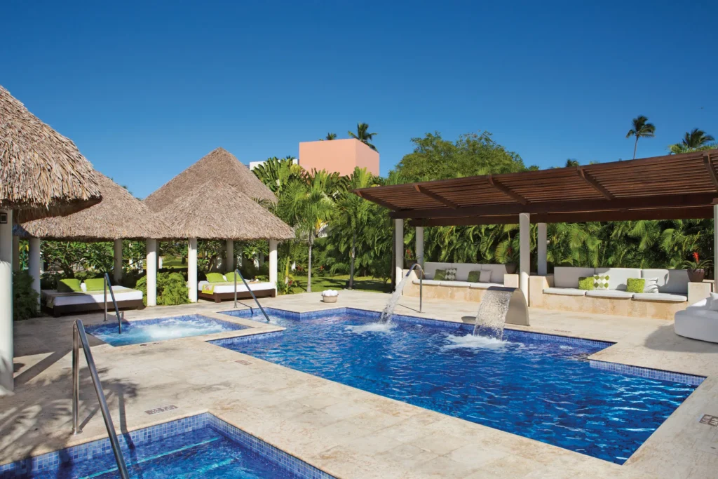 Outdoor spa circuit pools and relaxation areas at Dreams Royal Beach Punta Cana surrounded by tropical gardens.