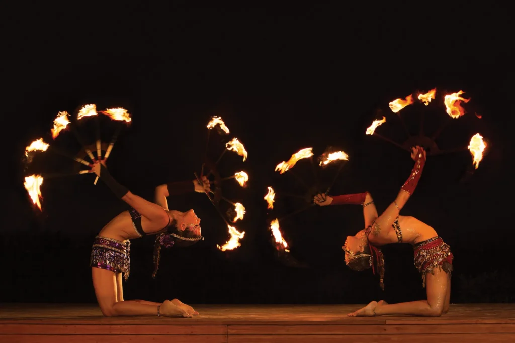 Fire performers entertaining guests during a nighttime show at Dreams Sands Cancun Resort & Spa.
