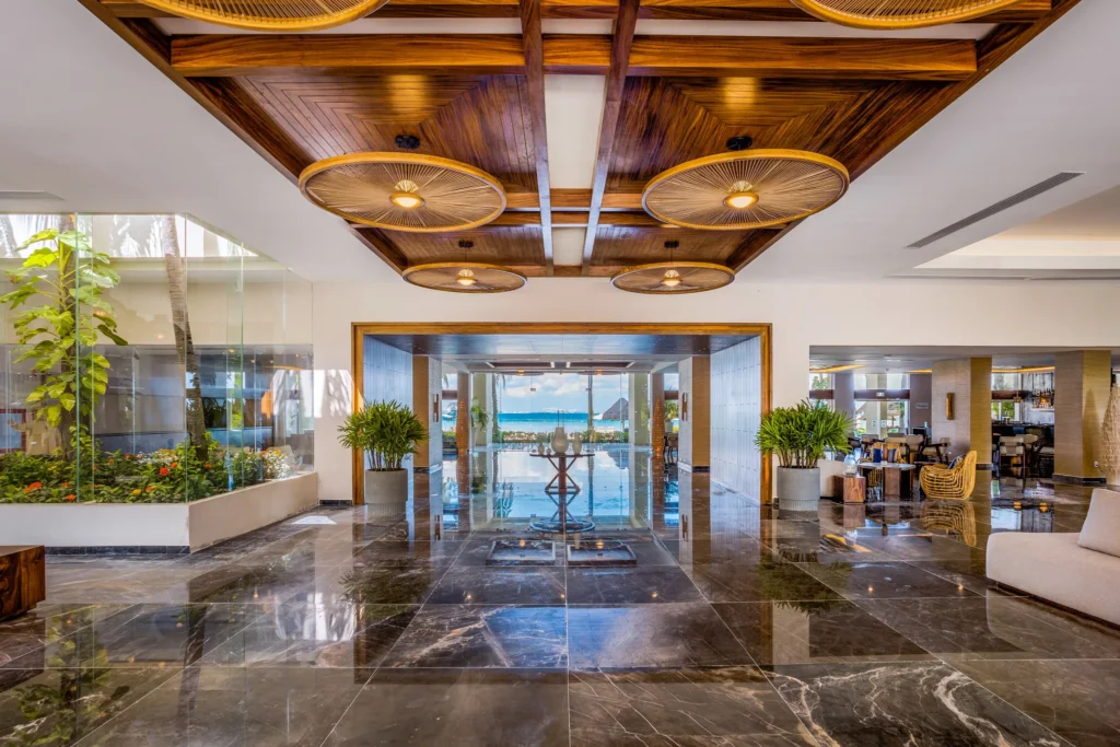 Spacious resort lobby with polished floors and ocean views at Dreams Sands Cancun Resort & Spa.