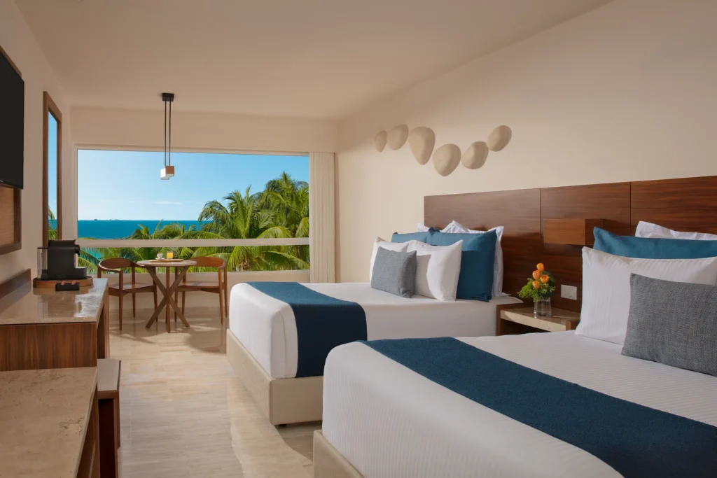 Double guest room with ocean view balcony at Dreams Sands Cancun Resort & Spa in Cancun.