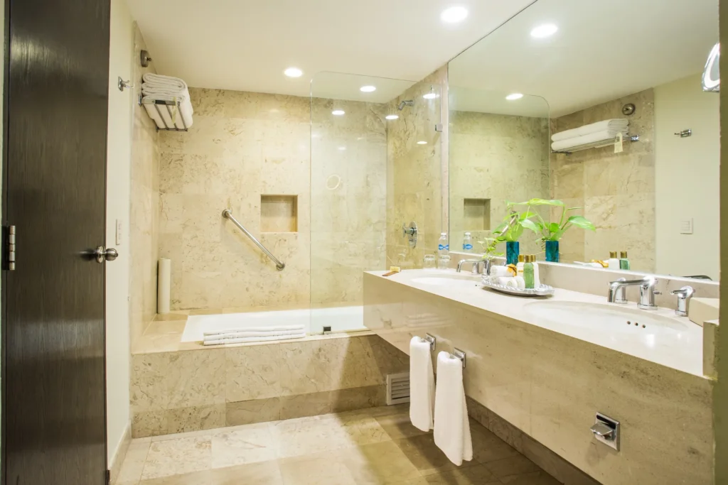 Preferred Club Junior Suite marble bathroom with walk-in shower at Dreams Sands Cancun Resort & Spa.