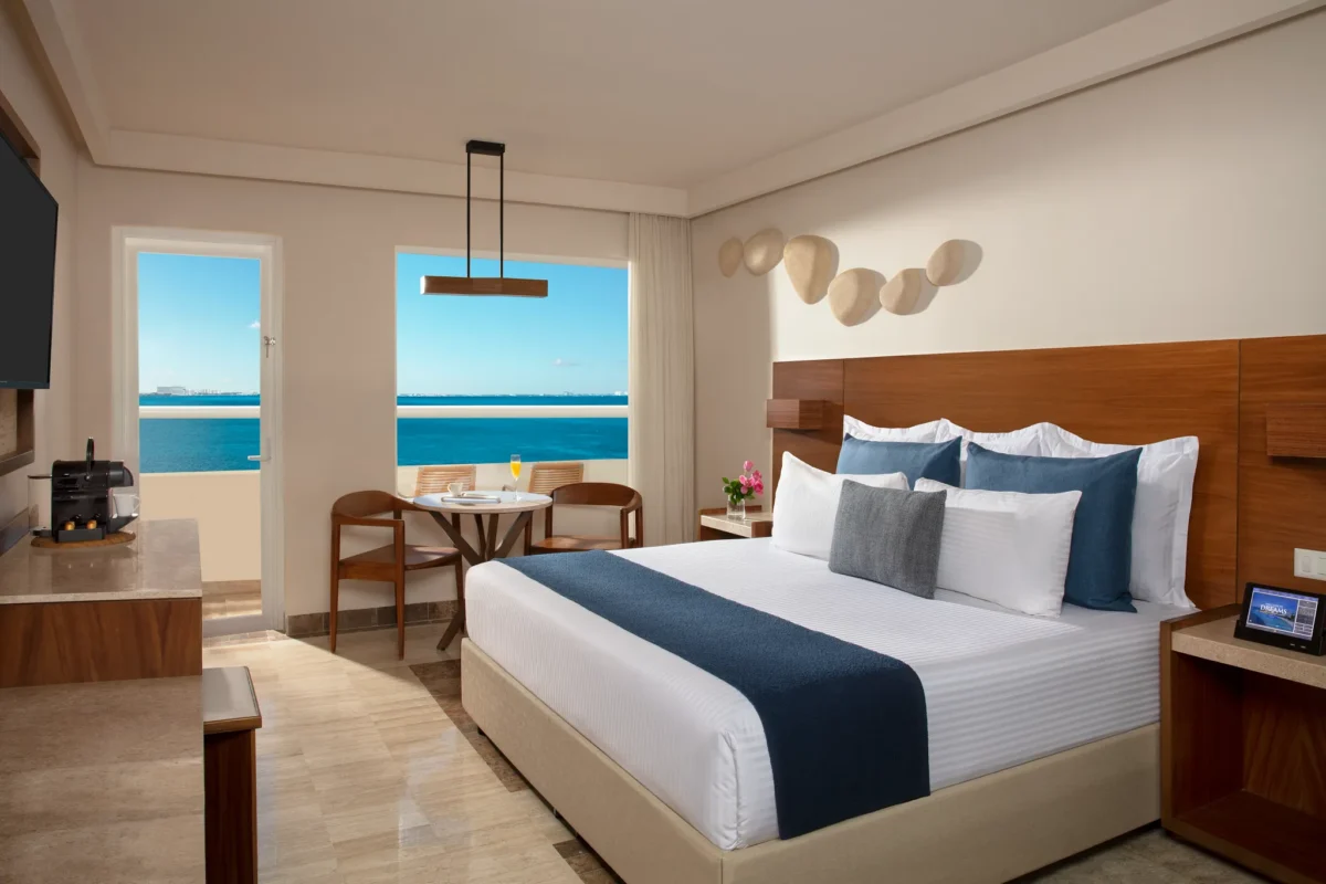 Preferred Club Premium Ocean Front king room with private balcony and Caribbean Sea views at Dreams Sands Cancun Resort & Spa.