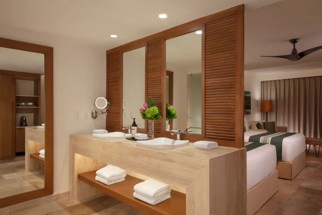 Club Junior Suite Ocean Front Double bathroom with dual sinks and open-concept vanity at Dreams Sapphire Resort & Spa.