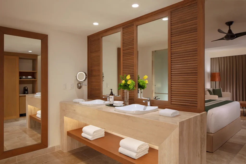 Club Junior Suite Ocean Front Swim Out Double bathroom with dual sinks and modern vanity at Dreams Sapphire Resort & Spa.