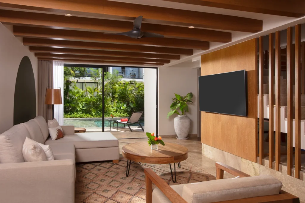 Club Two-Story Villa living room with seating area and pool access at Dreams Sapphire Resort & Spa.