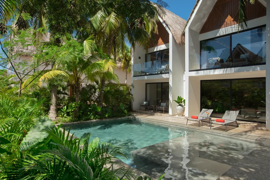 Club Two-Story Villa private heated pool surrounded by tropical landscaping at Dreams Sapphire Resort & Spa.
