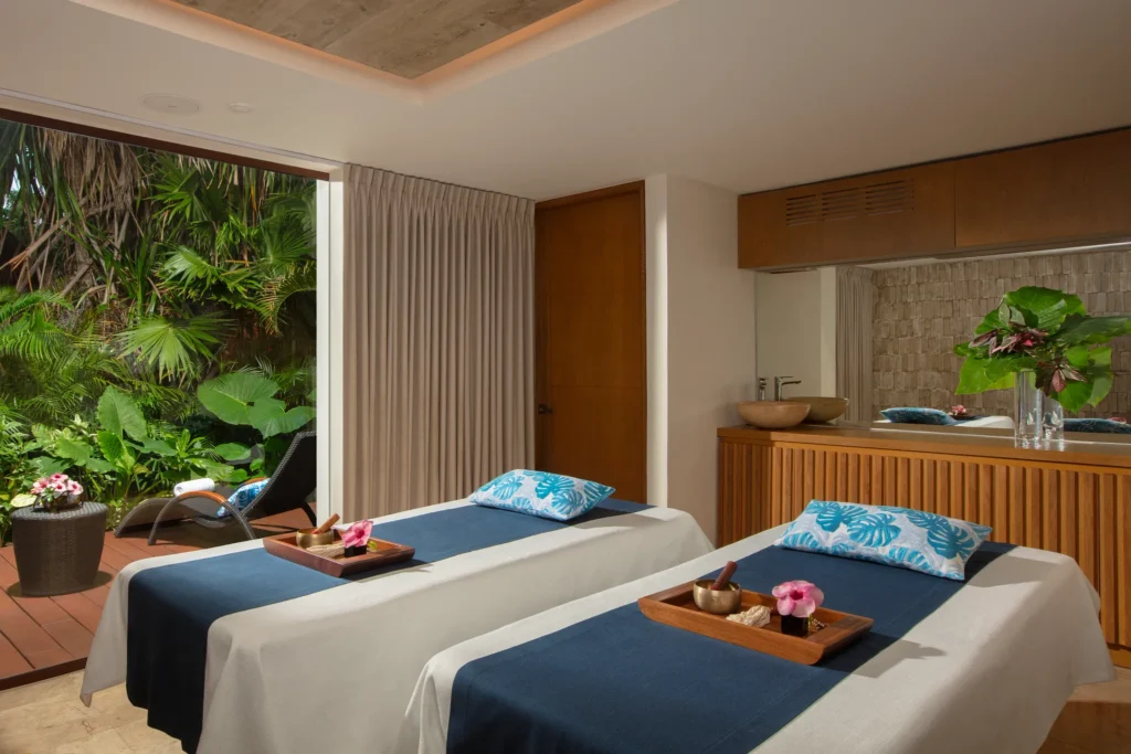 Private couples massage suite surrounded by tropical gardens at Dreams Sapphire Resort & Spa.
