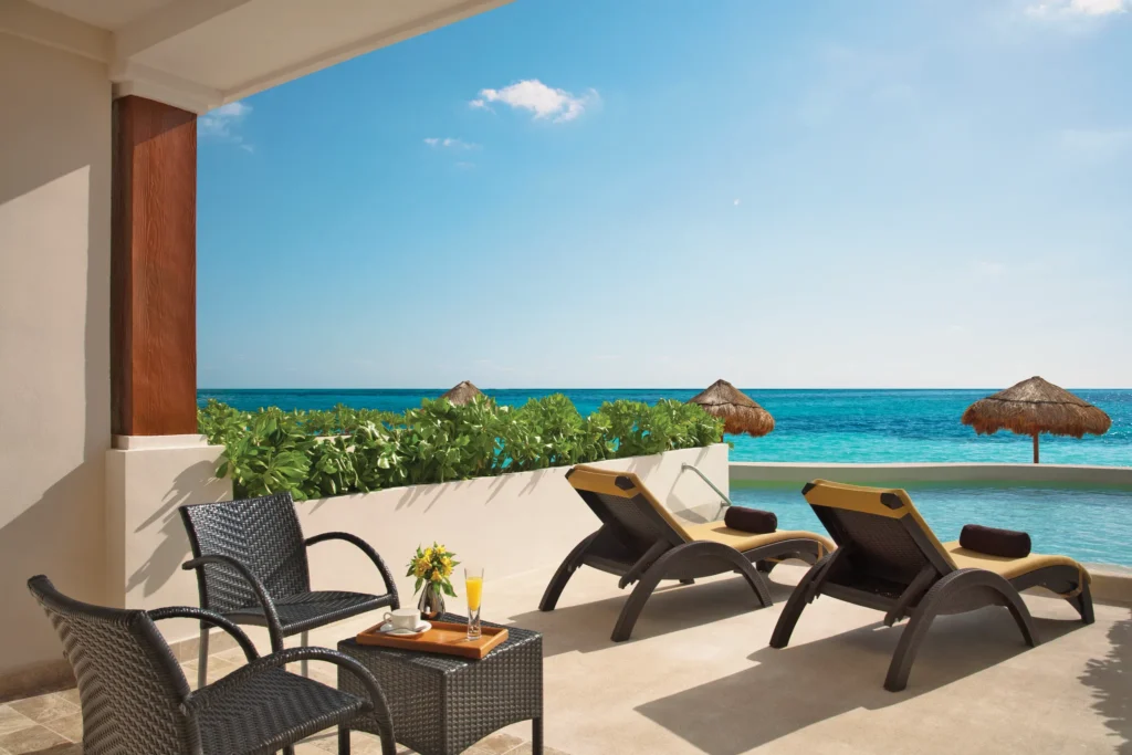 Private swim-out terrace with loungers and oceanfront views at the Preferred Club Junior Suite Beach Front Swim Out.