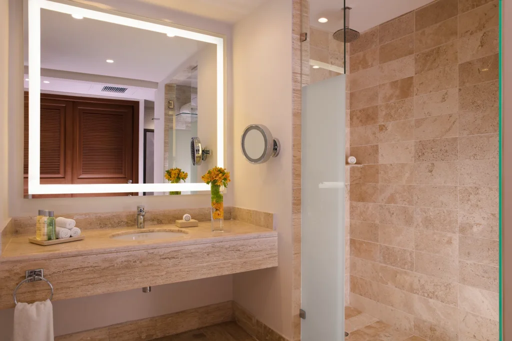 Preferred Club Junior Suite Tropical View bathroom with marble vanity and walk-in shower at Dreams Sapphire Resort & Spa.