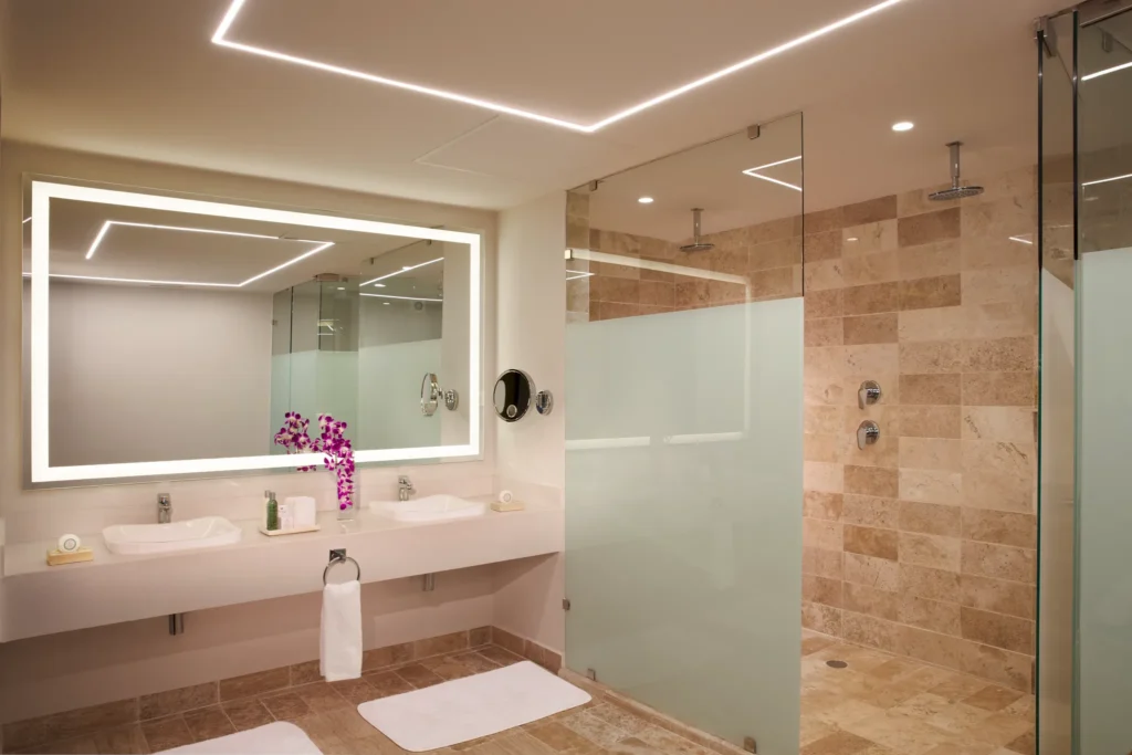Preferred Club Master Suite Beach Front Swim Out bathroom with double vanity and walk-in shower at Dreams Sapphire Resort & Spa.