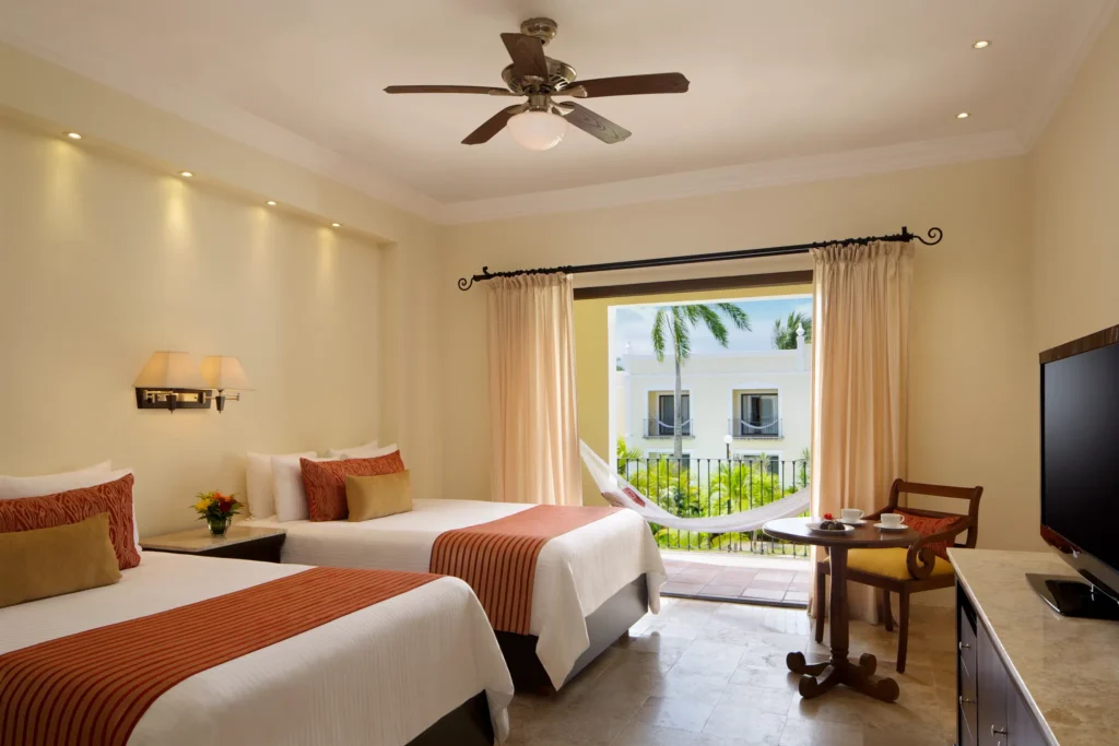Deluxe Garden View room with two double beds and furnished balcony at Dreams Tulum Resort & Spa.