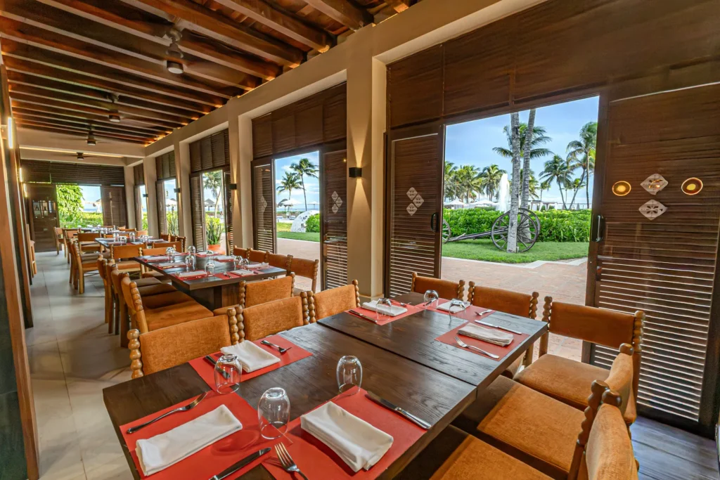 El Patio restaurant at Dreams Tulum Resort & Spa featuring vibrant Mexican-inspired décor, authentic cuisine, and a warm hacienda-style atmosphere.