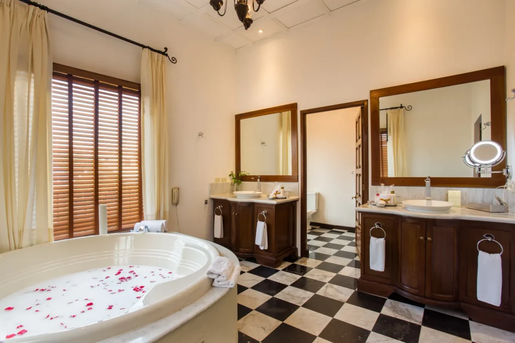 Preferred Club Hacienda Presidential Suite bathroom with hot tub, double vanities, and marble finishes at Dreams Tulum Resort & Spa.