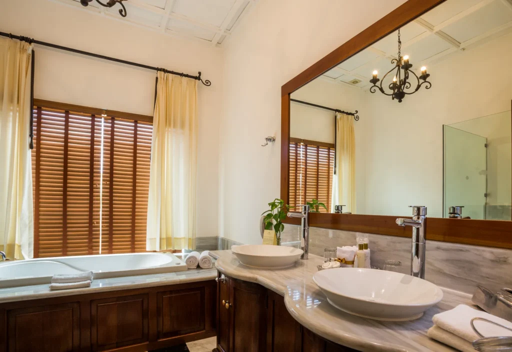 Full bathroom with double vanity, hot tub, and elegant marble finishes in the Preferred Club Hacienda Suite.
