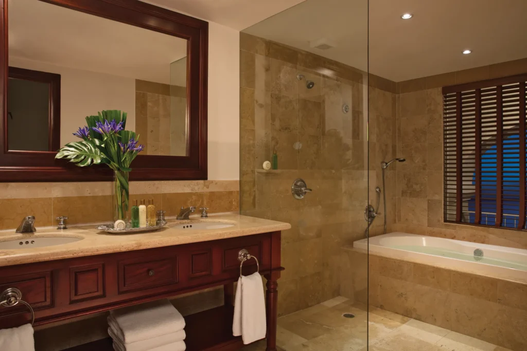 Marble bathroom with double sinks, soaking tub, and glass shower in the Preferred Club Junior Suite Ocean Front.